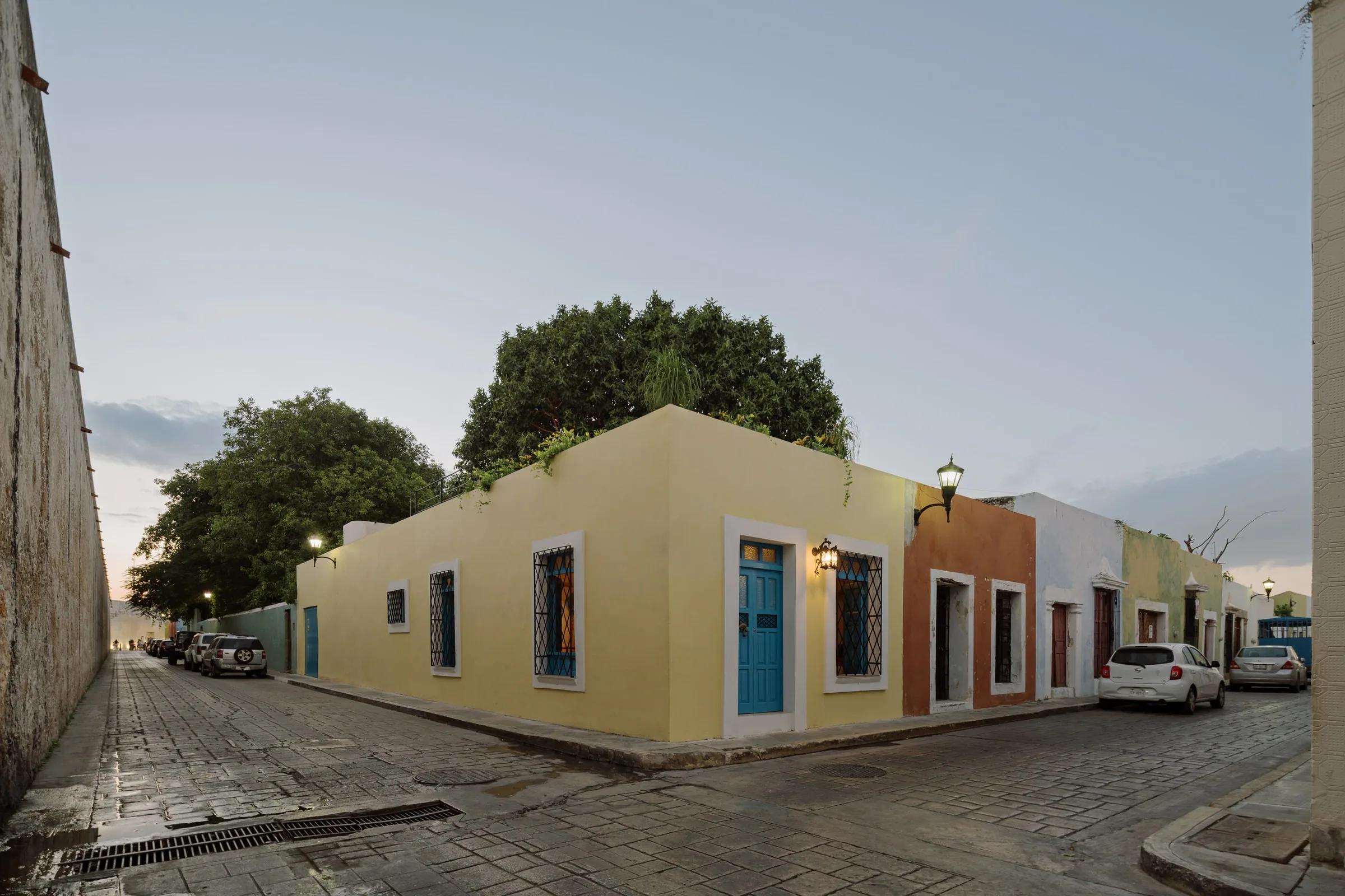 Casa Muralla and the coloured facades of its cobbled street at sunset, in Campeche
