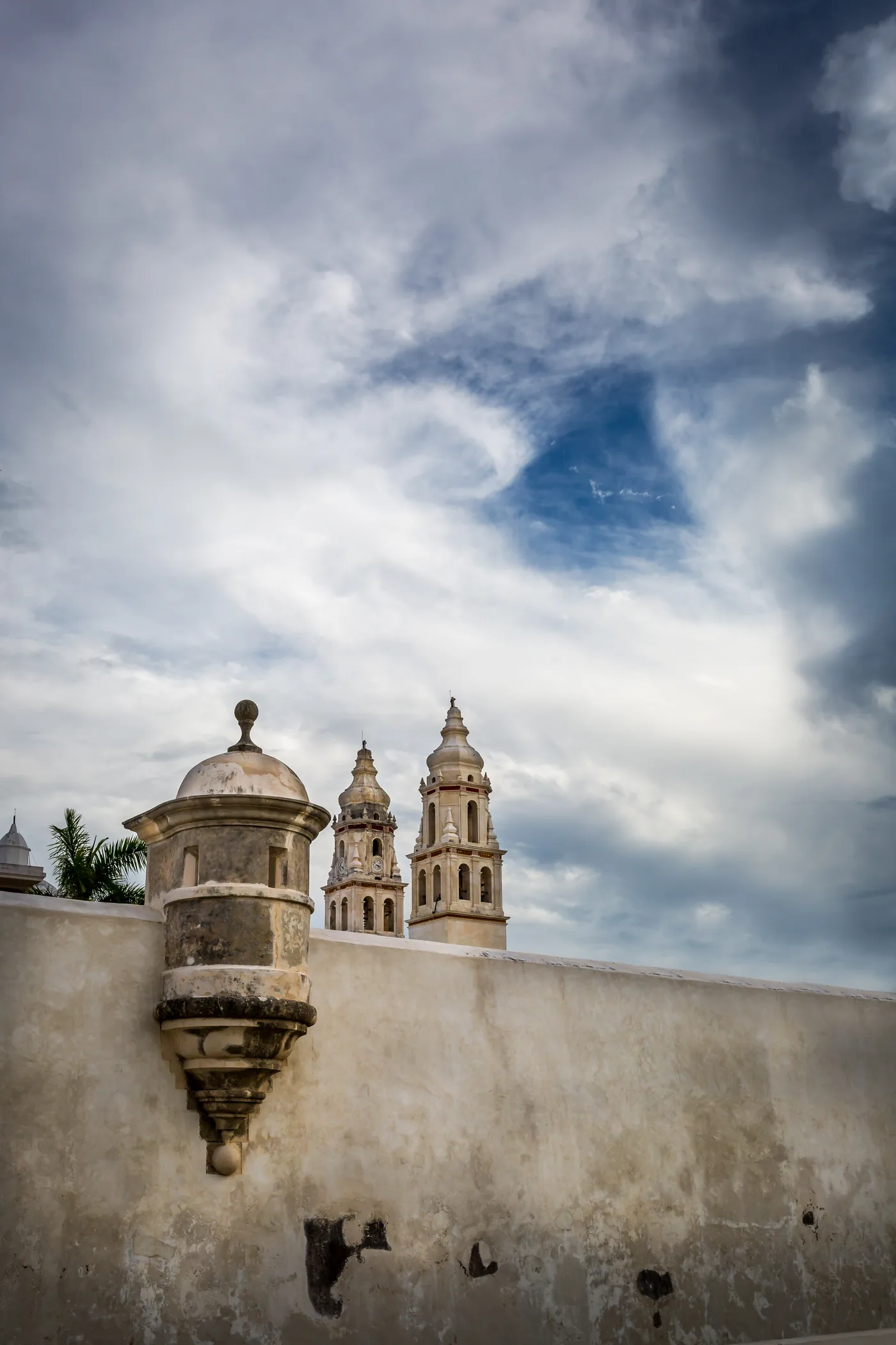 Sentry box on the Campeche city wall with the Cathedral towers behind